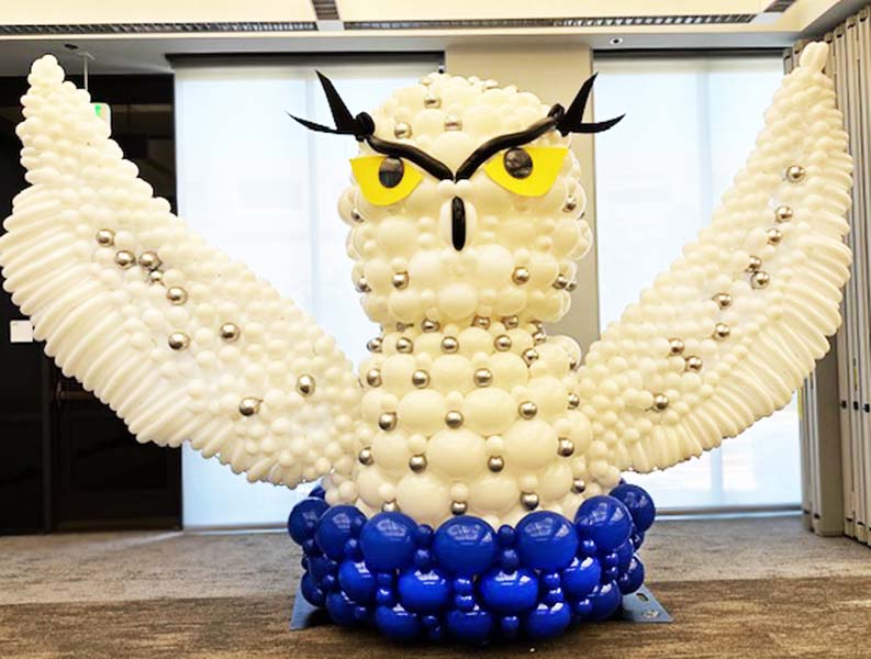 This 8 foot tall Snowy Owl balloon sculpture was created from white, silver and blue latex for a retirement party.