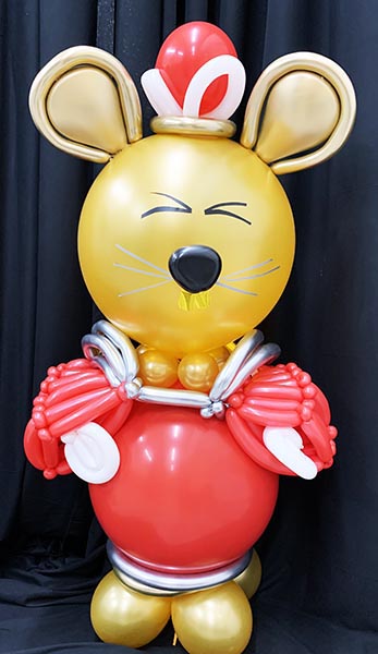 A 5 foot tall red and gold balloon sculpture of a rat for Chinese New Year.