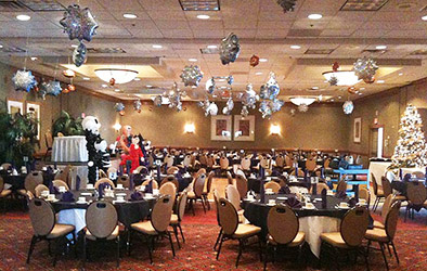 Sparkling mylar snowflake balloons placed accross the ceiling of this holiday party room to create a snowstorm illusion.
