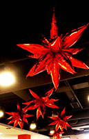 This 30 inch diameter cluster of red mylar leaf-shaped balloons is an eye-catching holiday party ceiling decoration