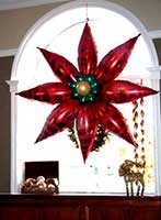 A four foot diameter red mylar balloon poinsettia serves as an elcellent perimeter or wall decoration
