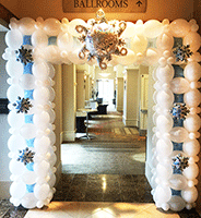 This eight foot tall entranece decoration spans this venue entrance with ballons and colors with the look of snow and ice