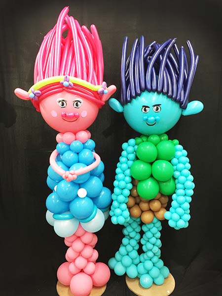 four foot tall balloon sculptures of trolls to serve as centerpieces at a childrens party