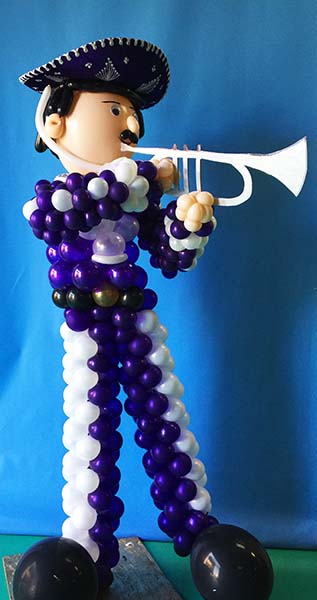A five foot tall balloon character sculpture of a trumpet playing Mariachi