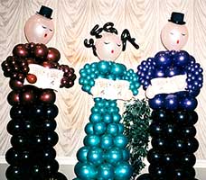 Balloon sculptures of three six-foot tall carolers for a corporate holiday party