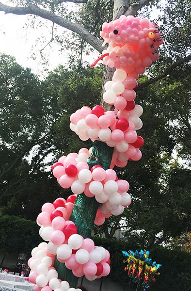 This 20 foot long serpent slinks from its coiled tree perch to greet guests at a child's birthday