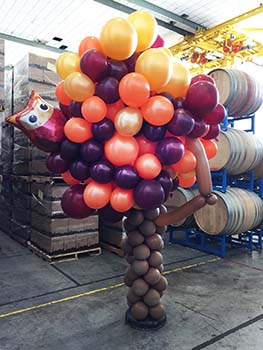 This eight foot tall clusted of harvest grapes is being used in a wine tasting room