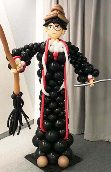 A 5 foot tall balloon sculpture of Harry Potter complete with broom and wand sculptued for a theme event.