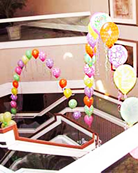 String of pearls arches in pastel colors decorating a stairway at a DoubleTree Hotel