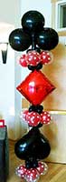 A red and black balloon column serves as an area decoration for casino theme events