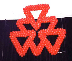 Giant suspended 5' balloon covered triangles logo for a corporate party
