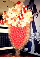 7 foot tall sculpture of a cherry soda used as part of the decor for a fifties party
