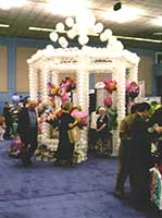 a striking white gazebo constructed from balloons for a trade show booth 