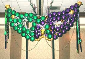 a giant Mardi Gras mask constructed from balloons and foamcor