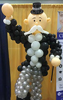 Balloonatics Old Big Bucks character balloon sculpture comes in formal dress wearing a ballon tuxedo with top hat and displays a classic large handlebar moustache