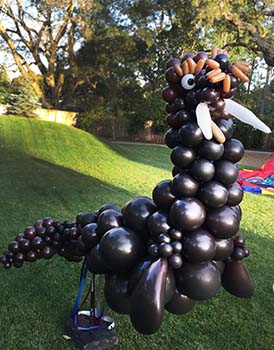 This 10 foot long balloon sculpture of a friendly walrus was created from brown balloons of different shapes for a theme birthday party.